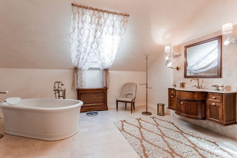 A warm and inviting bathroom showcasing a bathtub, vanity, and decor.