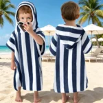 Navy blue and white striped hooded towel poncho for boys 2-4 years, front and back view on a beach