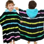 Front and back view of toddlers wearing black rainbow striped cotton hooded towel ponchos.