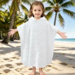 White children hooded poncho towel, kid model on tropical beach