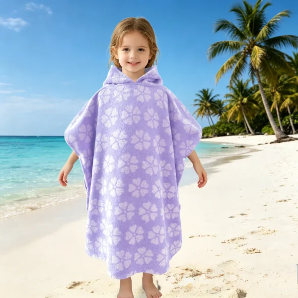 Child wearing an aqua purple striped hooded poncho towel after bath time