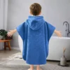 Solid Blue Embossed Kids Hooded Bath Poncho Boy Back View Beside Bathtub