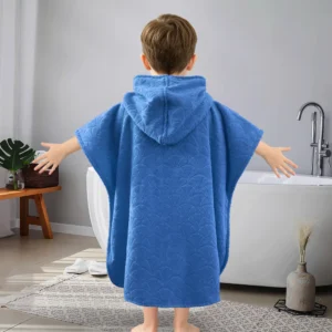 Solid Blue Embossed Kids Hooded Bath Poncho Boy Back View Beside Bathtub