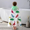 Dinosaur Kids Poncho Towel Bathroom Back View Back view of kid wearing dinosaur hooded poncho towel in bathroom, kids bath towel