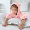 Pink Baby Hooded Bathrobe Lifestyle Baby wearing a soft pink hooded bathrobe