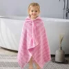 Child wearing a pink striped wearable hooded towel, front and back view