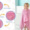 Child wearing a pink striped hooded towel after bath